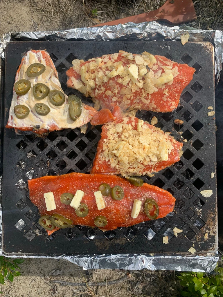 Salmon fillets cooking over charcoal